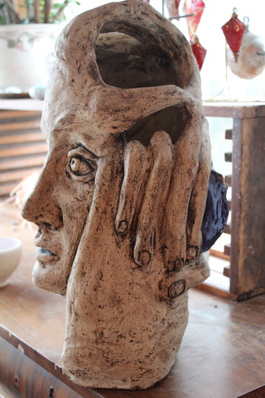 A sculpture formed by hand, using clay.