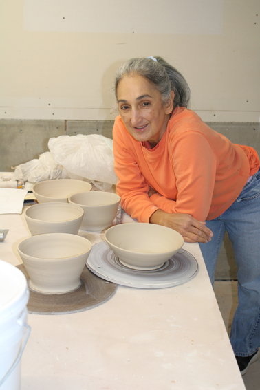 Rose Biondi with pots she is working on.