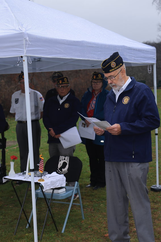 Warren Schloesser of the Honesdale American Legion explains the meaning and symbolism of the POW/MIA table.