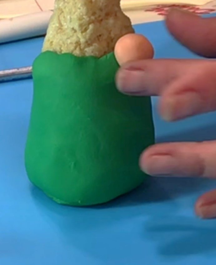 Roll some fondant (your choice of color) into a ball and add to the face as a nose.
