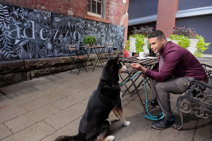 Dr. Kevin Beltré and his Siberian husky, Genji, enjoy a stop at a coffee shop in Scranton, PA. It’s one of the places the resident physician finds especially appealing in the community. ..