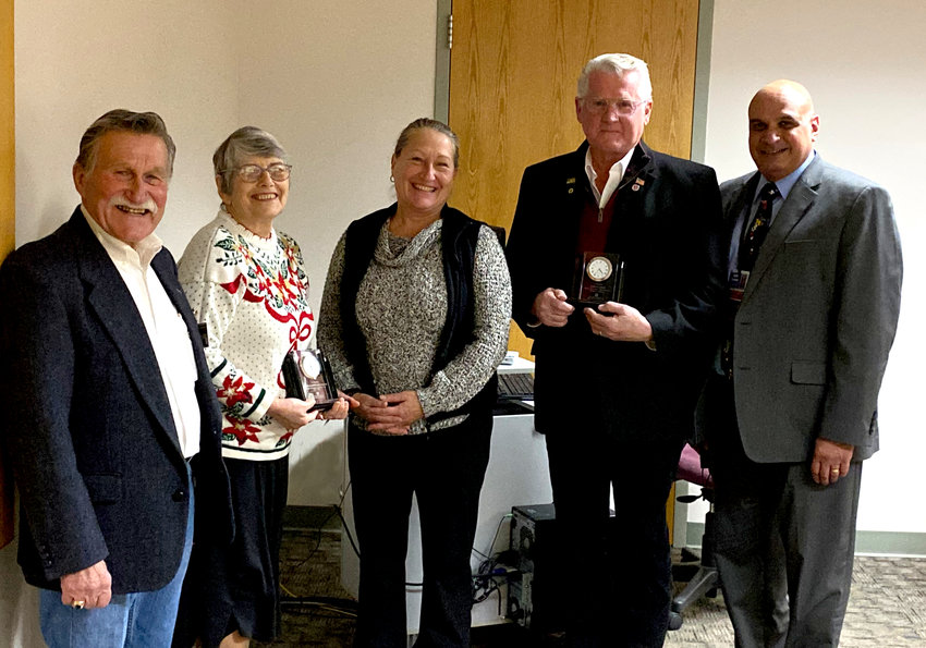 Honoring two retiring board members. Pictured are Hugh Rechner, left; Linda Harding-Buchmann; Christine Rechner; James Labar; and James Pettinato...