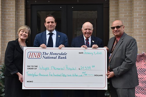 A gift from the Lemnitzer Memorial Fund will have a significant impact on the community. Pictured are Lisa Champeau, left; Charlie Curtin; Paul Meagher; and James Pettinato. 