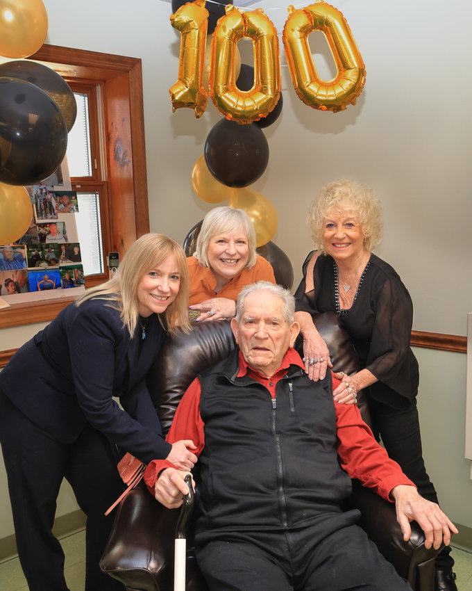 Raymond “Ray” Naholnik is surrounded by his daughters. Pictured are Sherrie Miller, left; Jeannie Torrick; and Sandy Culp. They are at the Adult Daily Living Center at the Hawley Senior Center during the celebration of Ray’s 100th birthday...