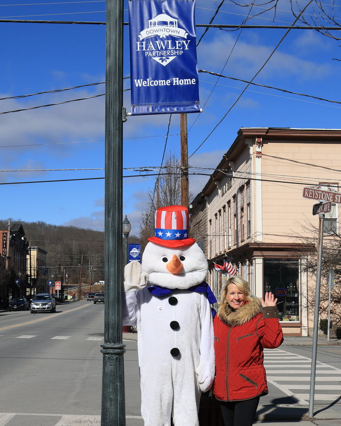 Linda Montana of the Downtown Hawley Partnership is pictured accompanying Wilburr. They strolled around Main Avenue in Hawley to kick off the annual “Where’s Wilburr”..scavenger hunt on Saturday, February 1.