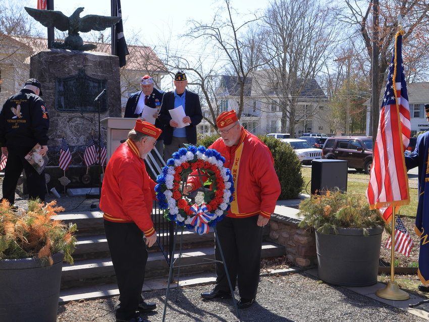 A ceremony was held on March 29, in honor of Vietnam Veterans Day, at the Soldiers and Sailors monument on Broad Street in Milford. On the same March day 50 years ago, the United States withdrew the last combat troops deployed in Vietnam. Pictured in the foreground, placing a wreath in front of  the monument, are Judge Advocate Ray Patterson, left, and Gary Brink, Commandant of Marine Corps League Detachment 909. At the top of the stairs are John Kupillas, Chaplain, American Legion Post 139, left; keynote speaker Gregory Protsko, Commander VFW Post 8612; and James Mulligan, Commander, American Legion Post 139...