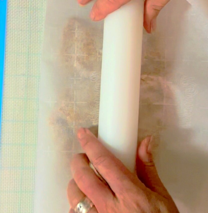 Pour filling out onto parchment paper. Fold paper over the top of filling. Roll flat with rolling pin...