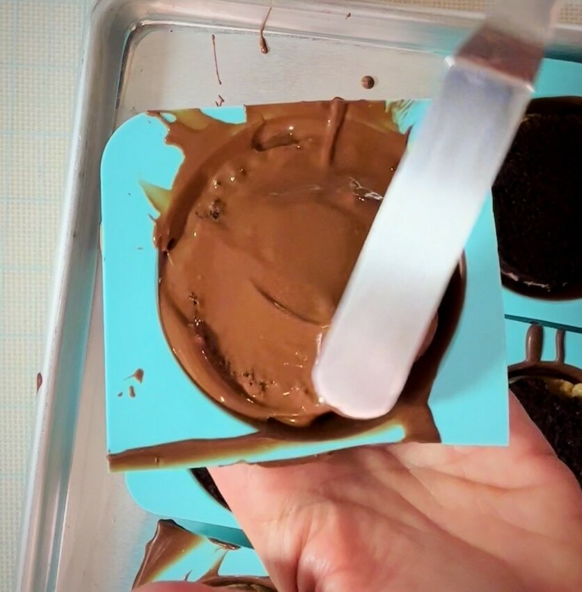 Melt more chocolate, and pour over the top of the cake. Let harden...