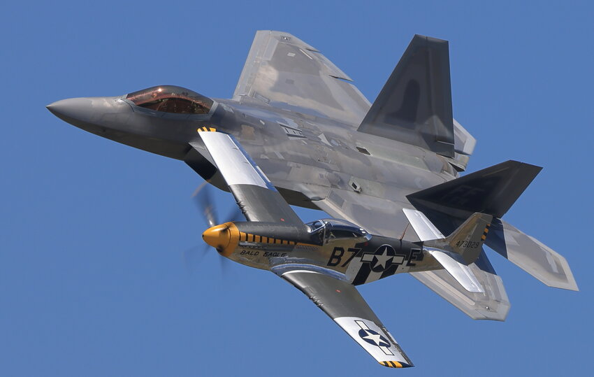 The F-22 Raptor makes a crowd-pleasing tandem pass with a vintage World War II P-51 piloted by a civilian in a memorial tribute to those who have served in the U.S. Air Force. It is known as the USAF Heritage Flight...
