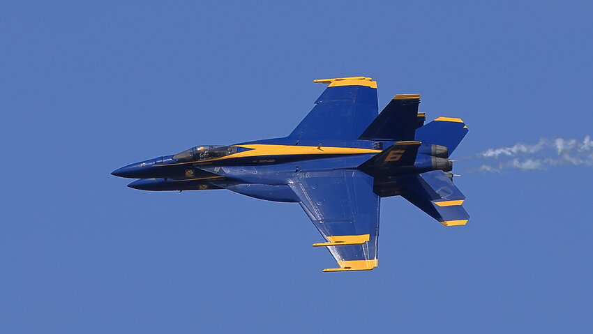 A tight formation of these two Blue Angels as they head into a coordinated barrel roll to an inverted position...