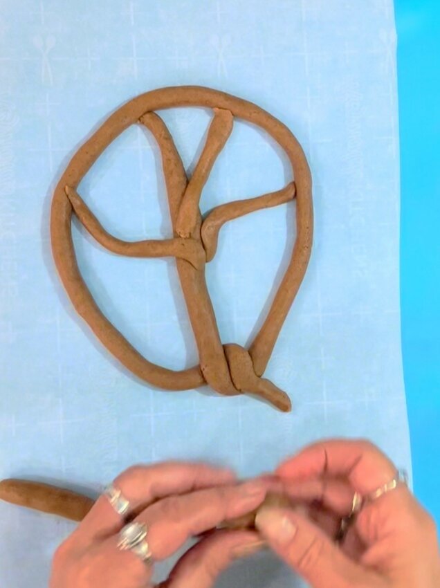Add pieces of dough, cut into various lengths, into the frame to look like tree branches.