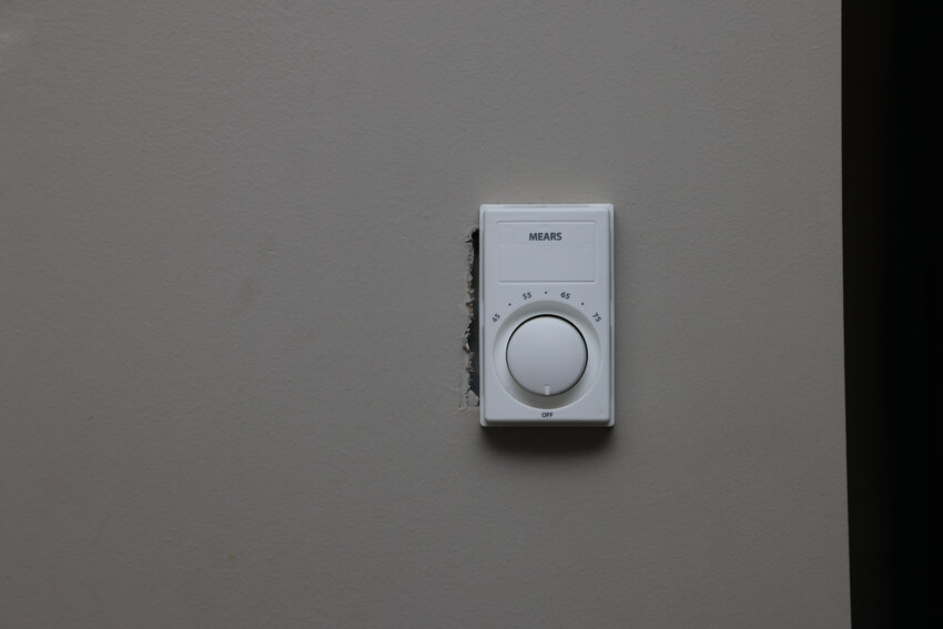 A poorly fitted thermostat installation.