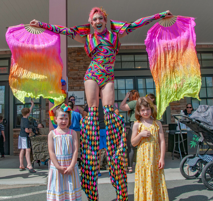 Five year-old Ember, left, and eight year-old sister Dove were all smiles with an extremely tall entertainer of indeterminate age at Rainbow Fest last weekend in Hurleyvville, NY.