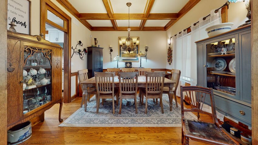The dining room has a white-oak floor, and a beautiful, solid-wood-beam coffered ceiling.