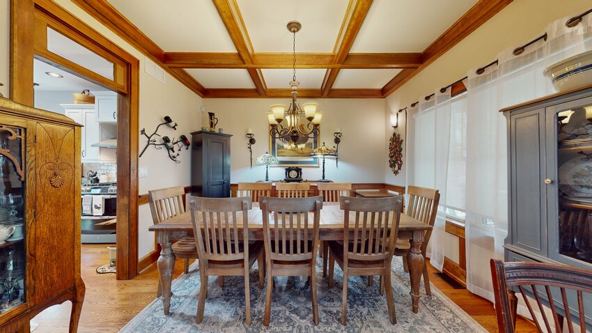 The dining room has a white-oak floor and a beautiful, solid-wood-beam coffered ceiling.