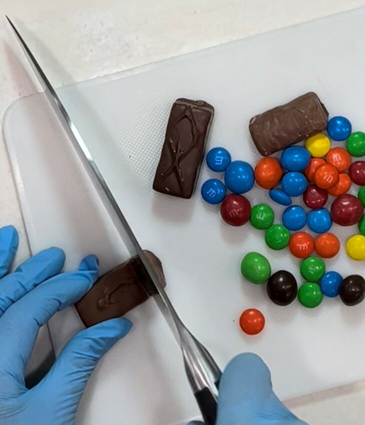 Slice the candy bars into smaller pieces, suitable for adding to a cookie.