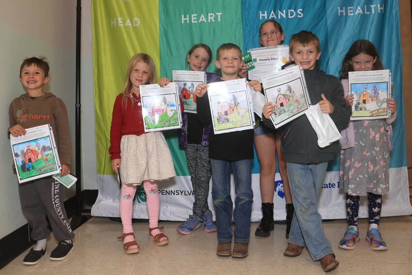 The 4-H coloring contest winners show off their work. Pictured are Henry Freidenstine (age 5, 1st place), left; Mallory Olver (age 6, 4th place); Lainey Henderson (age 7, 2nd place); Ryder Rutledge (age 6, 1st place); Victoria Polak (age 7, 5th place); Liam LaTourette (age 6, 2nd place); and Everly Zablocky (age 6, 3rd place).
