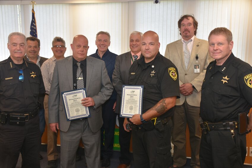 Detective Eric Breihof and Deputy Sheriff Sean Grady pose with the sheriff, undersheriff and members of the legislature after receiving their certificates of merit for saving a child at Swinging Bridge Reservoir. (Photo provided by the Sullivan County Sheriff's Officer