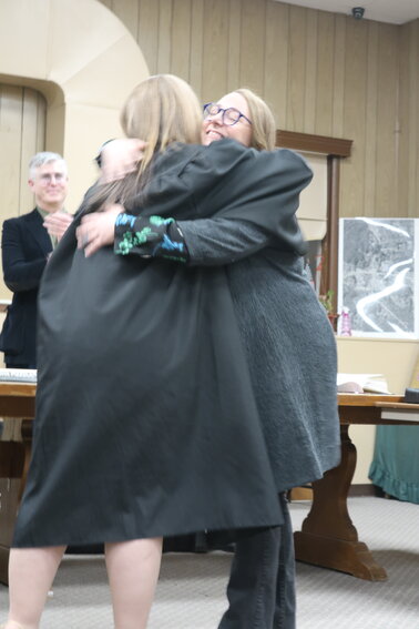 Newly elected councilperson Laura Burrell gives judge Meagan Galligan a big hug after being sworn in.