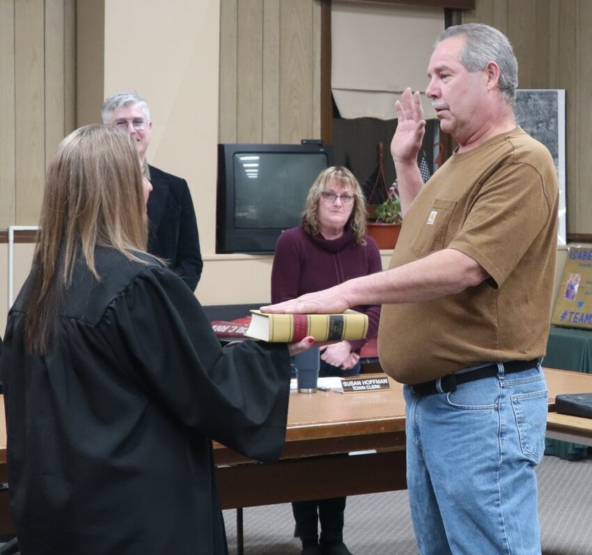 Supreme Court Justice Meagan Galligan, center, left, administers the oath of office to Highland Highway Superintendent Joe Barnes.