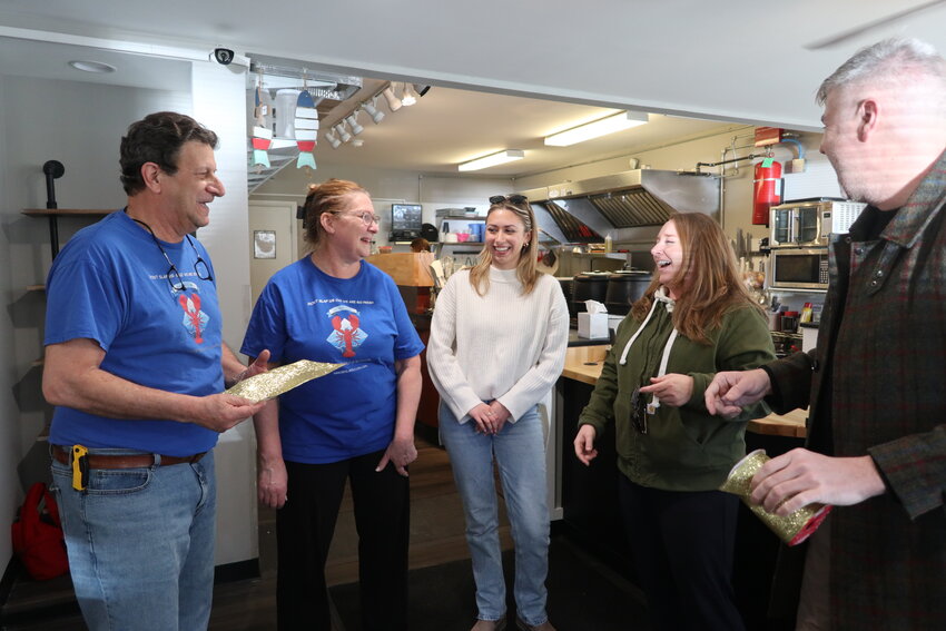 The March 30 ribbon cutting was sponsored by the Greater Barryville Chamber of Commerce. Highland supervisor John Pizzolato, right, and Greater Barryville Chamber of Commerce President Laura Burrell congratule the Chiocchi family on the opening of Nikki C's Seafood and Catering.