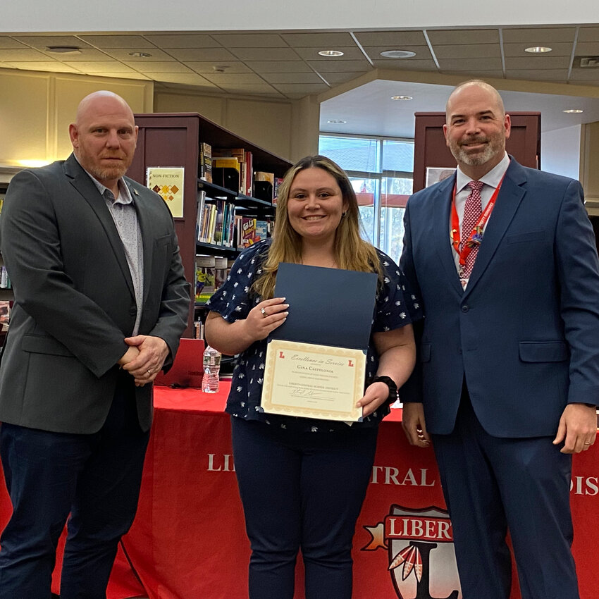 Liberty Central School District's Gina Castelonia is pictured center, with school board president Matthew DeWitt at left and superintendent Dr. Patrick Sullivan at right. Castelonia was recognized with an Excellence in Service award for April. 