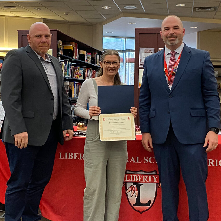 Liberty Central School District's Jennifer Eisenberg is pictured center, with school board president Matthew DeWitt at left and superintendent Dr. Patrick Sullivan at right. Eisenberg was recognized with an Excellence in Service award for April. 