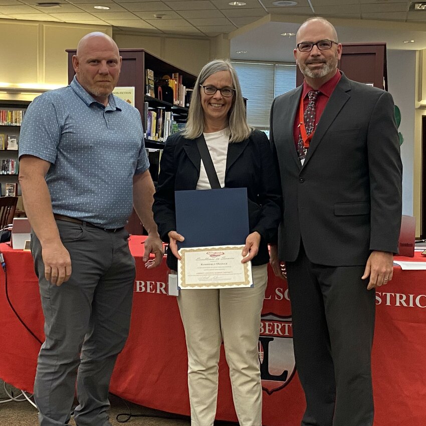 Kim Heinle is pictured in the center, with Liberty Central School District board president Matthew DeWitt to her right and superintendent Dr. Patrick Sullivan on her left.
