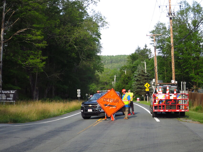 Highway workers block off NYS Route 97 north of the Il Castello parking lot, at River Road in Barryville, at about 6:30 p.m. Tuesday evening.