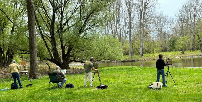 Plein air artists along the Delaware at a Callicoon painting event.