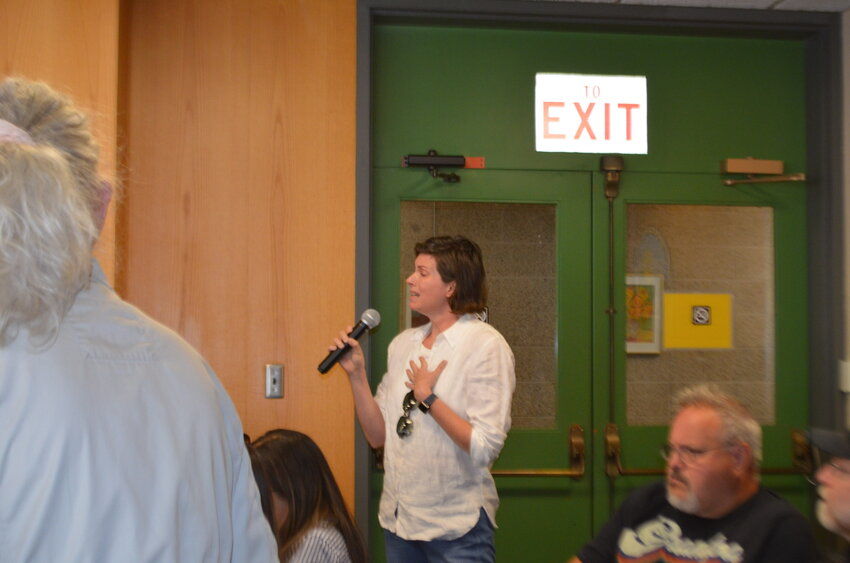 Katie Childs, a mother of two,  addresses the town hall and asks Jerry Dunlavey, CEO of Garnet Health Medical Center - Catskills, a question.