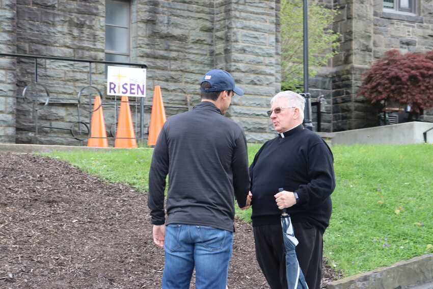 Representative Rob Bresnahan, left, meets with Reverend William Langan of St. John's Church.