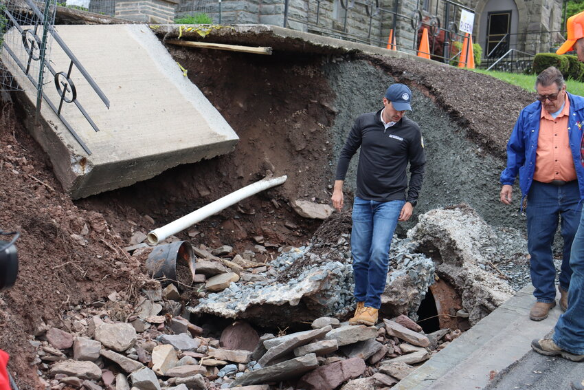 Representative Rob Bresnahan stands atop the rubble from the Tuesday, May 6 flooding.