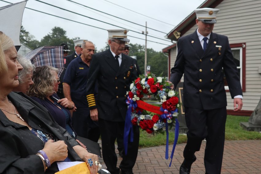 Local fire chiefs and emergency responders carry in the remembrance wreath at Highland&rsquo;s 9/11 ceremony on September 11 in Heroes Park in Eldred.