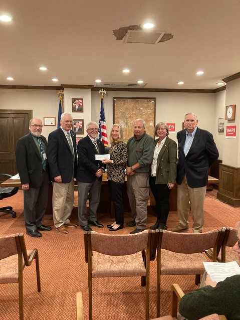 Commissioners Tony Waldron, left, Ron Schmalzle and Matt Osterberg present a check to GPCF Executive Director Jennifer Hamill. GPCF treasurer Robert Martin, GPCF chair Gail Shuttleworth and PCESI donor William Lovejoy were also on hand for the presentation.