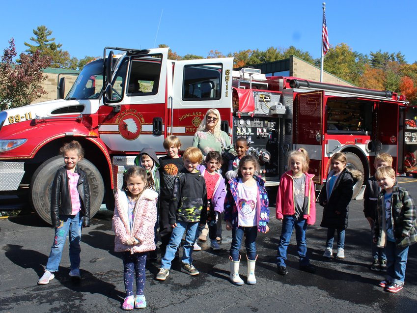 First graders, accompanied by their teacher Mrs. Morsch, inspected equipment on Highland Lake Fire Department&rsquo;s Engine 69-11 as part of Fire Prevention Week. ..