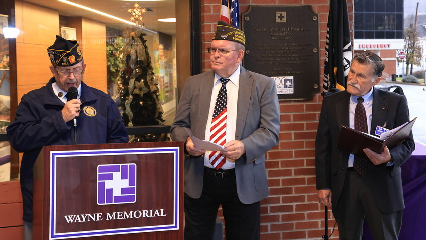Jim Bruck, American Legion Post 254, left; Rev. Dale Pepper, VFW Post 531; and Hugh Rechner, the chairman of the board for Wayne Memorial Hospital and the Wayne Memorial Health System, U.S. Army (ret.), tell the story of &ldquo;a day of infamy&rdquo; outside the main entrance to the Wayne Memorial Hospital on the anniversary of the attack on Pearl Harbor, December 7, 2022.....