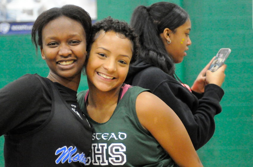 Taking a break. The Homestead School&rsquo;s Ayana Banks, right, strikes a pose in between events with a runner from Monticello.