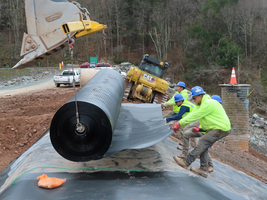 After excavating down to the subgrade layer, the construction team gets to work on &ldquo;the heart of the project,&rdquo; unrolling 400 feet of a durable geomembrane to prevent water seepage during a flood.