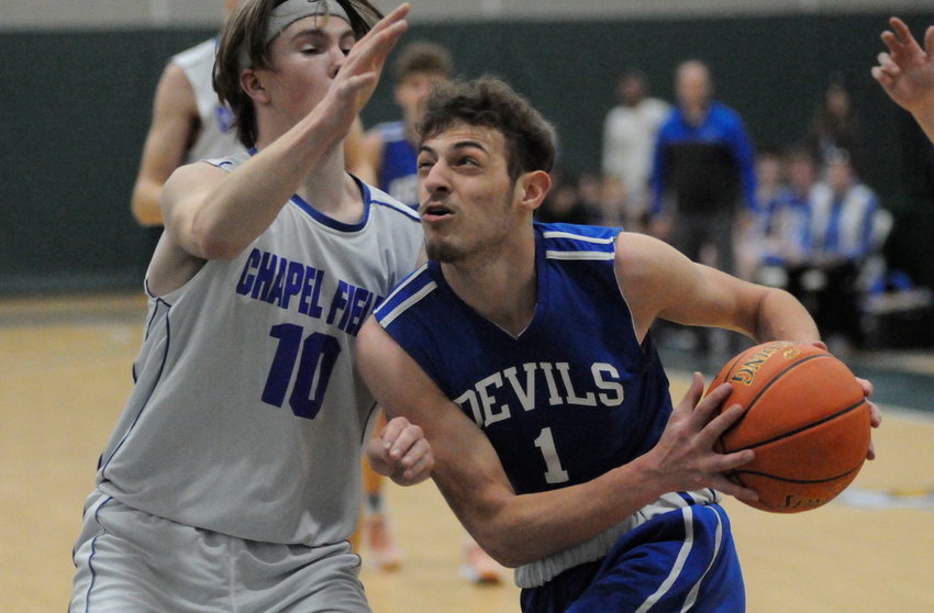 Looking at the ceiling. Roscoe&rsquo;s Anthony Teipelice eyes the glass-backed rim against Chapel Field defender Leam Powell.