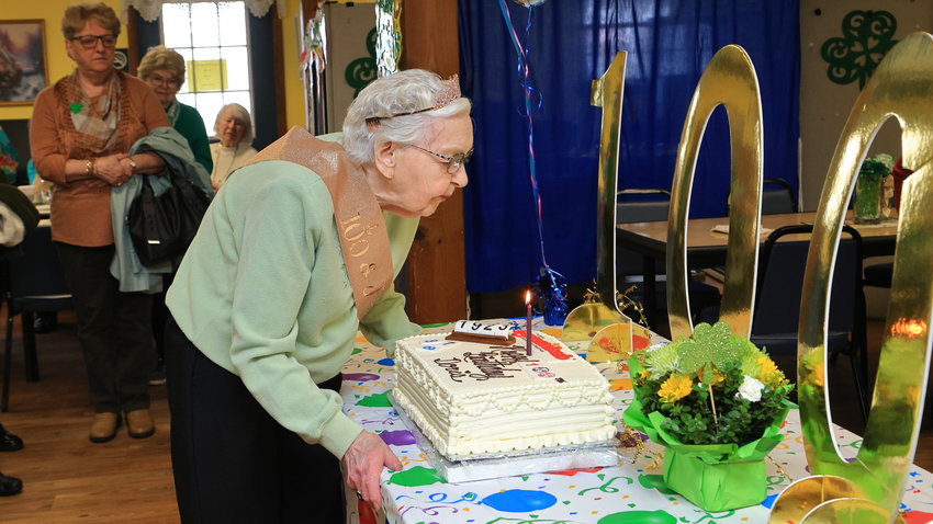 Mrs. Doris Day is pictured just before blowing out the candle on her 100th birthday cake.