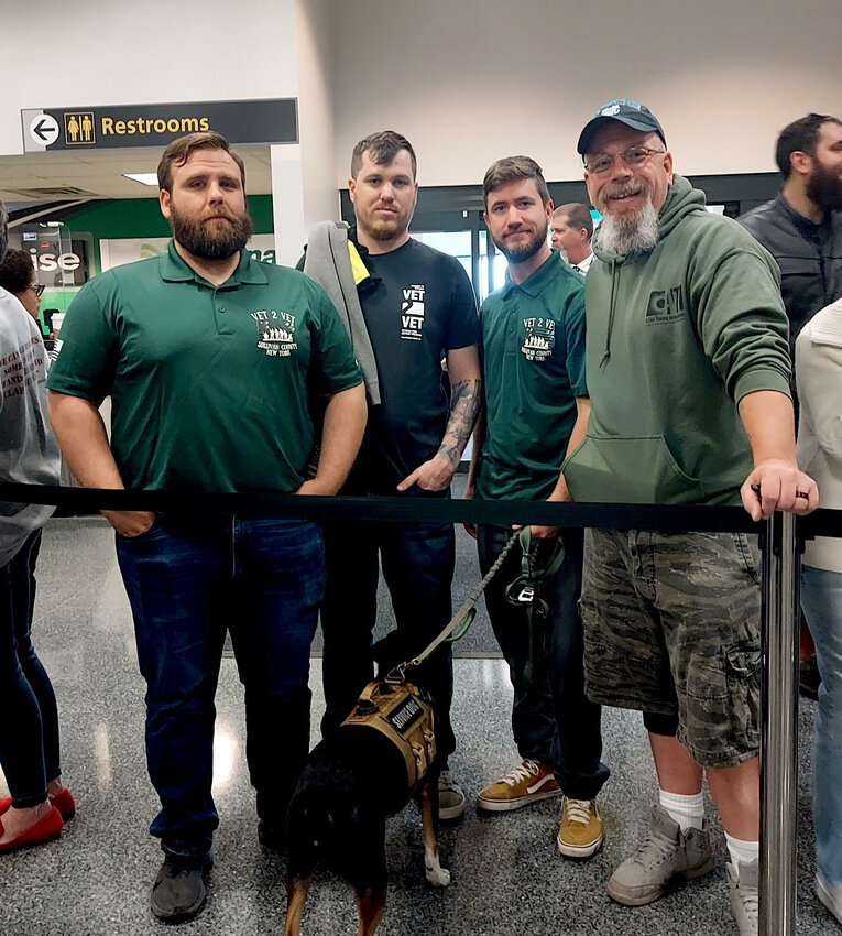Local Veterans from Vet 2 Vet of Orange and Sullivan counties were on hand to send off the veterans and their guardians on the Hudson Valley Honor Flight. Pictured are Ryan Fuller, left; Tom Hauber; Stephen Murphy; Murphy&rsquo;s service dog, Eva; and Jimmy Raftery.
