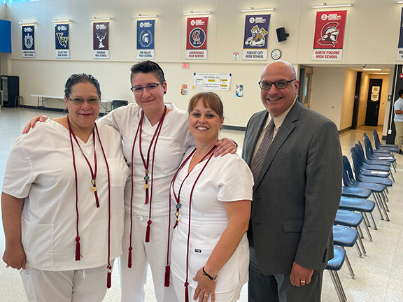 New practical nurses have completed their training and will work at Wayne Memorial Hospital. Pictured are Mary Jane Lawal, left; Jessica Peterson; Dorothy Tighe; and hospital CEO James Pettinato...