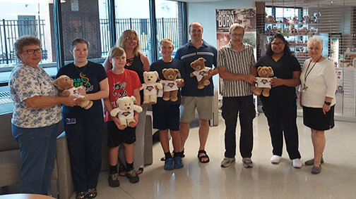 Holding a bear makes blood tests a little less scary, so the Garing family donated six bears. Pictured are Nancy Garing, left; Valerie Martin; Logan Garing; Rebecca Garing; Tyler Garing; Shawn Garing; Walter Garing; Katrina Torchio; and Joyce Malicky...