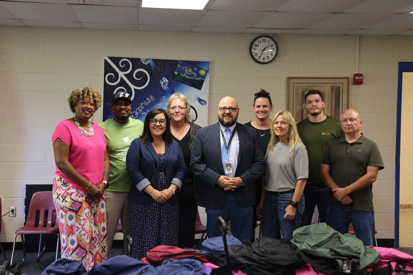 Providing backpacks for kids in Fallsburg. Pictured are ATI&rsquo;s Children and Family Services Program Manager Akilah Sutphin, left; NYSEG&rsquo;s Program Manager, Uthman Aziz; Fallsburg&rsquo;s Director of Pupil Personnel Services Leighanne Russell; Assistant Superintendent for Curriculum and Instruction Sally Sharkey; Superintendent Dr. Ivan Katz; NYSEG&rsquo;s Gabi Matthews; Dena Schulte; Travis Kelly; and NYSEG Regional Manager John Schneck.