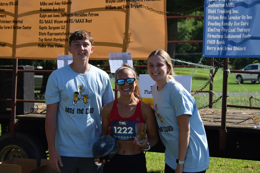 Pictured, center, is Jennifer Nolan, 42, Narrowsburg, NY, the female 10K winner of the Herd the Curd 5K race with a time of 47:55. Bryce Shannon (not pictured) won the male 10K title with a time of 39:57. ..