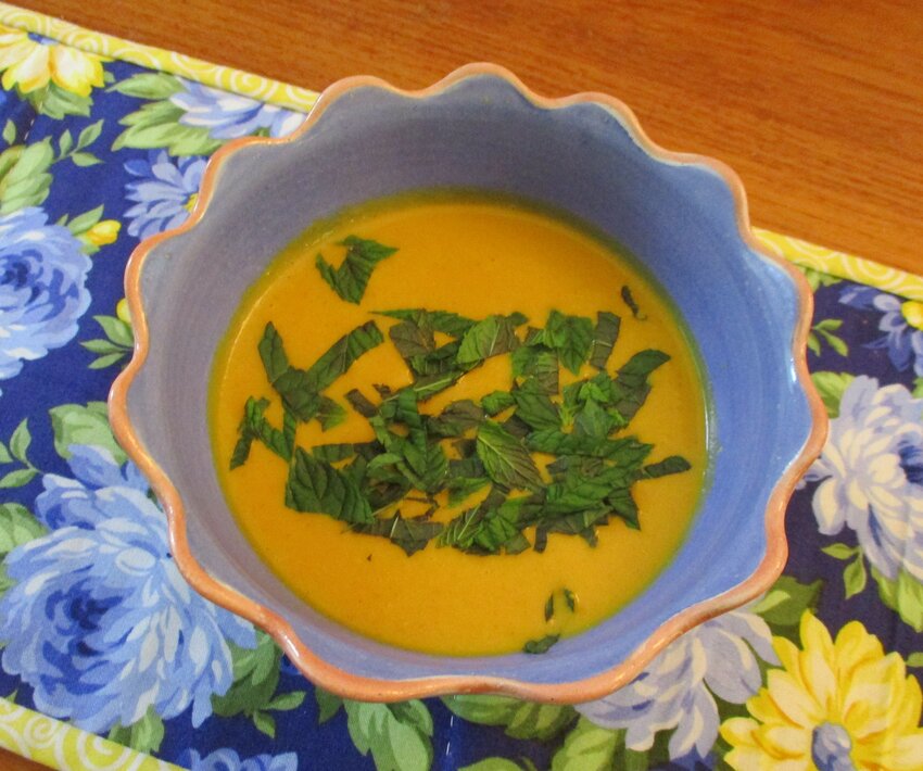 Curried cream of carrot soup, garnished with fresh mint