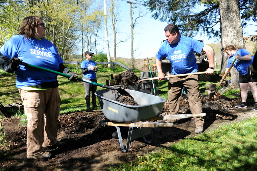 Volunteers work on the Fremont Park fire pit in May.