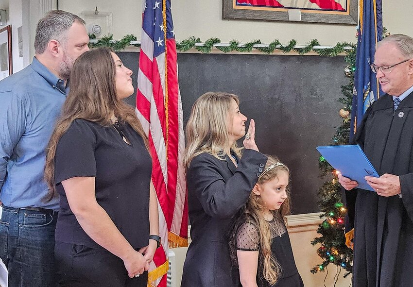 Suzanne Edzenga was sworn in by Lumberland Town Justice Craig Cherry. She is accompanied by her husband, Daniel, and children Ksenia (oldest), and Elsa (youngest).