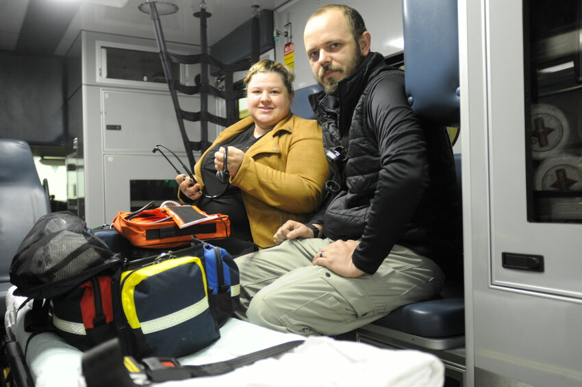 Captain Kaitlin Duffy and Lt. Connor Duffy are pictured with emergency medical equipment in one of the corps&rsquo; two ambulances.